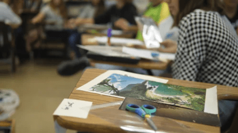 Childs desk with art and scissors on top