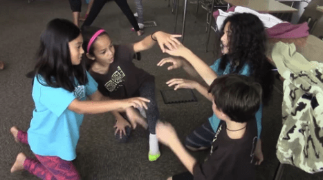 4 kids playing a game in a circle