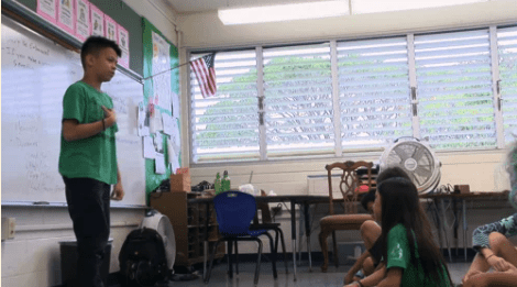 Young kid standing in front of the classroom