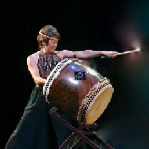 Chizuko Endo with a taiko drum and drumstick.