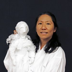 Bonnie Kim holding a puppet.