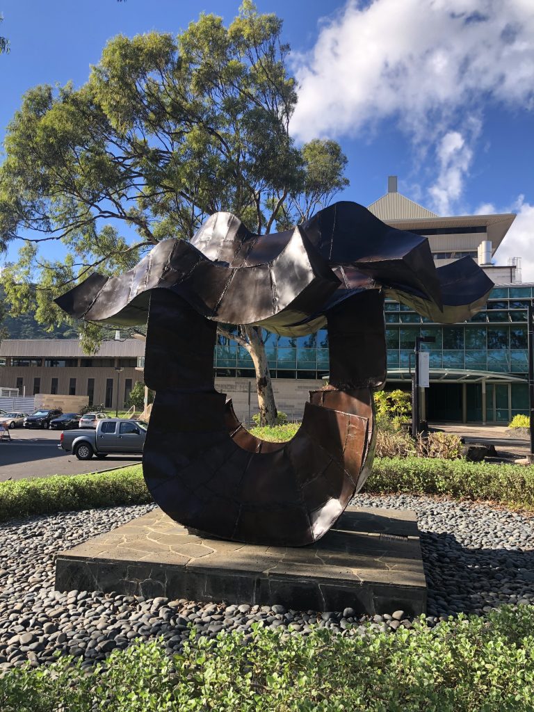 Copper sculpture on stone plinth in front of University of Hawaii-Manoa Center for Microbial Oceanography: Research and Education (C-MORE).