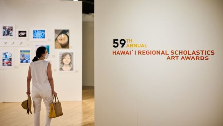 Person walking into museum gallery.