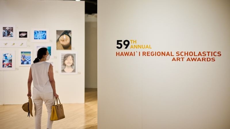 Person walking into museum gallery.
