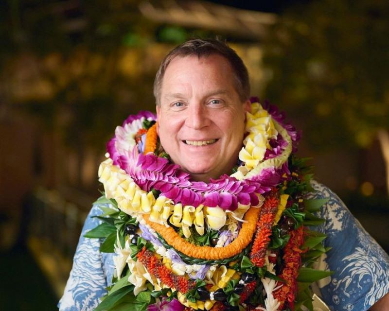 Jonathan Johnson in aloha shirt and several lei