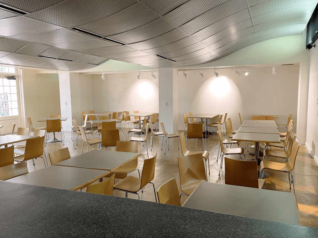 Indoor cafe space with tables and chairs