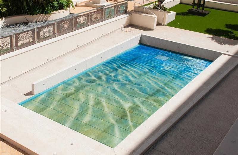 Glass tiles in shades of green and white, mimicking water.